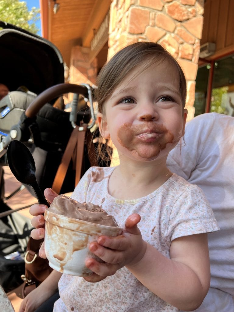 Little girl with chocolate all over her face.