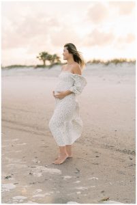 Woman holding baby bump during maternity session in Jacksonville, FL.