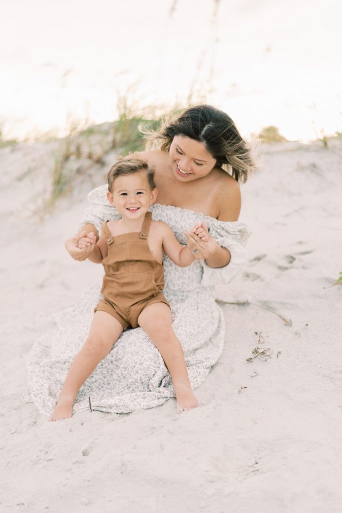 Mother holding son on her lap during family photos.